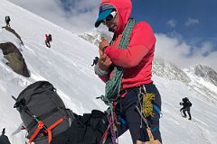 05A Climbers Continue Climbing While Guide Pachi Ibarra Rests In The Rock Band On The Climb Up The Fixed Ropes To High Camp